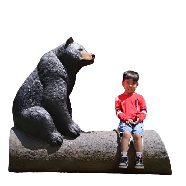 BEAR ON TREE TRUNK
